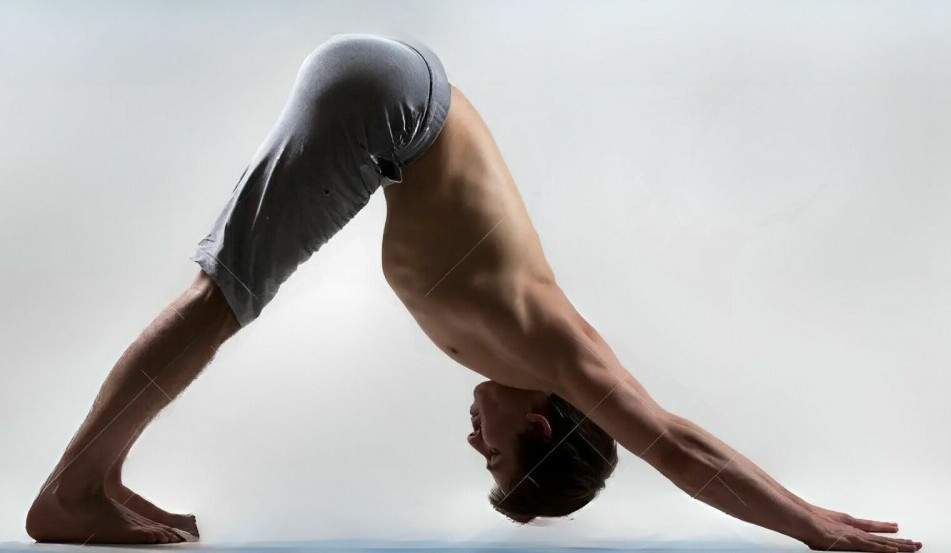 man doing downward facing dog pose