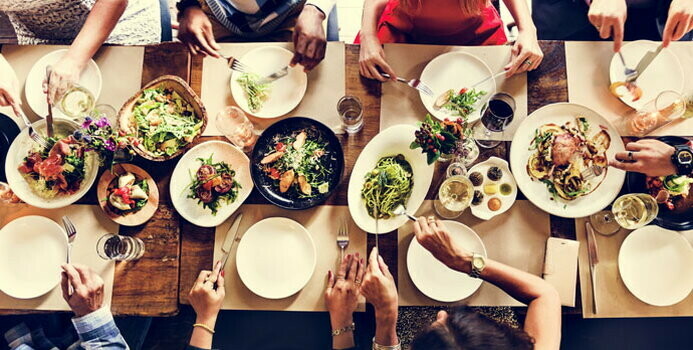 people eating dinner at a large table