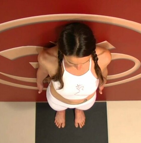 woman doing mountain pose against wall